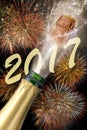 Bottle of champagne with popping cork at new years 2017 Royalty Free Stock Photo