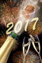 Bottle of champagne with popping cork at new years 2017 Royalty Free Stock Photo