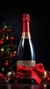 Bottle of champagne with a red ribbon and Christmas decorations on a black background Royalty Free Stock Photo