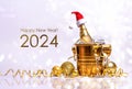 A bottle of champagne with a red santa claus cap in a golden bucket with ice and two glasses Royalty Free Stock Photo