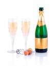 Bottle of champagne, two crystal glasses and a cork stopper isolated on white background with shadow reflection. Royalty Free Stock Photo