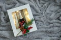 A bottle of champagne and two glasses with a luminous garland in a cardboard box with  Christmas tree branch. Against the Royalty Free Stock Photo