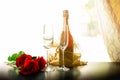 Bottle of Champagne and two glasses with rose flowerin the room. Royalty Free Stock Photo