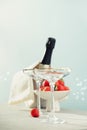 Bottle of champagne, two glasses and strawberries on sea and sky background Royalty Free Stock Photo