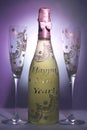 Bottle of champagne and two glasses decorated with the message happy new year Royalty Free Stock Photo