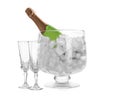 Bottle of champagne in vase with ice and flutes Royalty Free Stock Photo