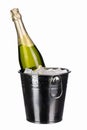 a bottle of chilled sparkling champagne with water drops and ice cubes in a metal bucket on a white isolated background Royalty Free Stock Photo