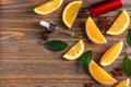 Bottle of citrus essential oil and orange slices on wooden table Royalty Free Stock Photo