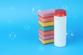 A bottle of cleaning agent and a set of colorful foam sponges on a blue background Royalty Free Stock Photo