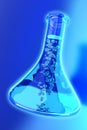 The bottle of clear liquid on blue background