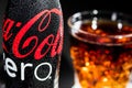 Bottle of Coca Cola Zero with drops and Glass with the Ice Cubes Royalty Free Stock Photo