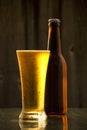 A bottle of cold draft beer with a glass Royalty Free Stock Photo