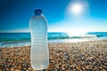 Bottle of cold fresh water on the pebble beach Royalty Free Stock Photo