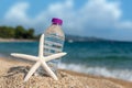 Bottle of fresh cold water on beach sand Royalty Free Stock Photo