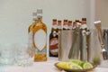 Bottle of cold vodka and wine bottle in bucket with ice and orange juice in jug on table, copy space. Alcohol bottles in ice Royalty Free Stock Photo