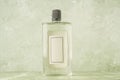 Bottle of cologne with empty label over green Royalty Free Stock Photo