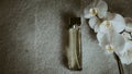 bottle of cologne, flowers on a gray background. Top view Royalty Free Stock Photo