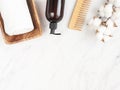 Bottle container with pump mock up, towel, wooden hair comb on white marble background Royalty Free Stock Photo