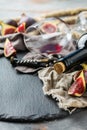 Bottle, corkscrew, glass of red wine, figs on a table Royalty Free Stock Photo