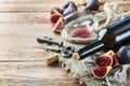 Bottle, corkscrew, glass of red wine, figs on a table Royalty Free Stock Photo