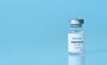 Bottle of Covid-19 vaccine to immunize from the Omicron Variant Coronavirus on blue background. The concept of medicine,