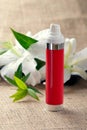 Bottle of cream/lotion with lilies Royalty Free Stock Photo