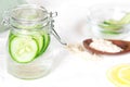 Bottle with cucumber water on white background. Fresh skin care tonic