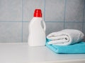 Bottle of detergent and clean towels on washing machine indoors, space for text. Laundry day Royalty Free Stock Photo