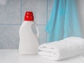 Bottle of detergent and clean towels on washing machine indoors, space for text. Laundry day Royalty Free Stock Photo