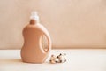 Bottle of detergent on white wooden background.