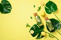 Bottle of detox water with mint, lemon and tropical monstera leaves on yellow background. Flat lay. Citrus lemonade Royalty Free Stock Photo