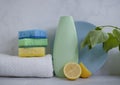 Bottle of dish detergent, lemon, sterilize sponge on a light background