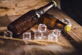 Bottle Draft Beer and ice on wooden table Royalty Free Stock Photo