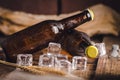 Bottle Draft Beer and ice on wooden table Royalty Free Stock Photo