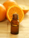 bottle of essence oil and fresh oranges Royalty Free Stock Photo