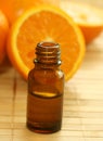 bottle of essence oil and fresh oranges Royalty Free Stock Photo
