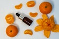 A bottle of essential oil, Aromatic tangerine oil in a dark bubble, cosmetic oil from tangerine. Royalty Free Stock Photo