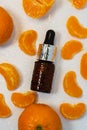A bottle of essential oil, Aromatic tangerine oil in a dark bubble, cosmetic oil from tangerine. Royalty Free Stock Photo