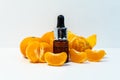 A bottle of essential oil, Aromatic tangerine oil in a dark bubble, cosmetic oil from tangerine. Bottles with sweet orange essenti Royalty Free Stock Photo