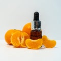 A bottle of essential oil, Aromatic tangerine oil in a dark bubble, cosmetic oil from tangerine. Bottles with sweet orange Royalty Free Stock Photo