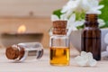 Bottle of essential oil and jasmin flower with shallow depth of