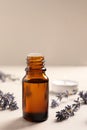 Bottle of essential oil and lavender flowers on white wooden table, closeup Royalty Free Stock Photo