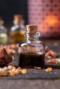 A bottle of myrrh essential oil with myrrh resin Royalty Free Stock Photo