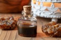 A bottle of myrrh essential oil with myrrh resin crystals Royalty Free Stock Photo