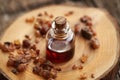 A bottle of essential oil with myrrh resin Royalty Free Stock Photo