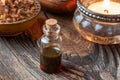 A bottle of essential oil with myrrh resin on a rustic background Royalty Free Stock Photo