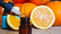 Bottle of essential oil from oranges on wooden background with pieces of oranges - alternative medicine. Essential aroma oil with Royalty Free Stock Photo