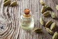 A bottle of cardamon essential oil with cardamon seeds Royalty Free Stock Photo