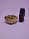 A bottle of essential oil with whole cardamon seeds in a traditional spice pot Royalty Free Stock Photo