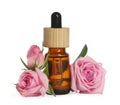 Bottle of essential rose oil and flowers against white background Royalty Free Stock Photo